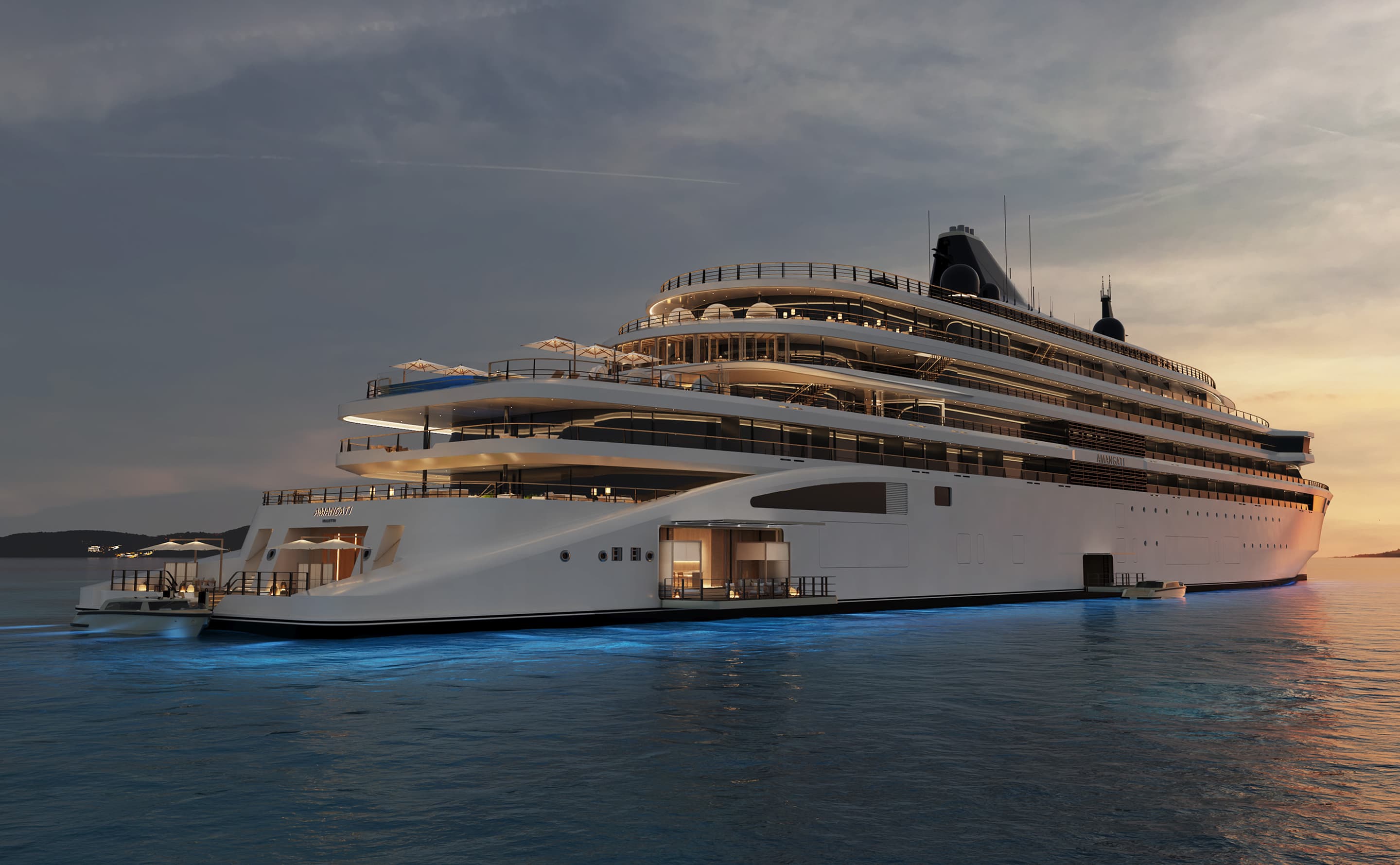 The Amangati superyacht by Aman at sunset with blue underwater lighting